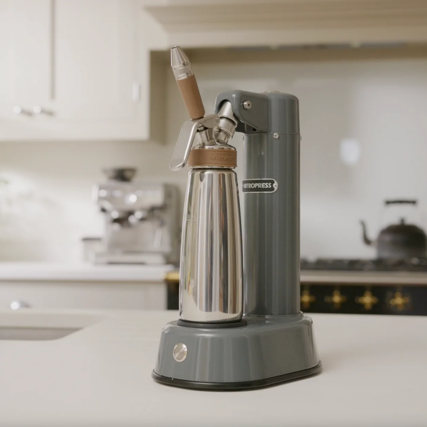 Gray Nitro coffee maker on a kitchen counter with blurred background